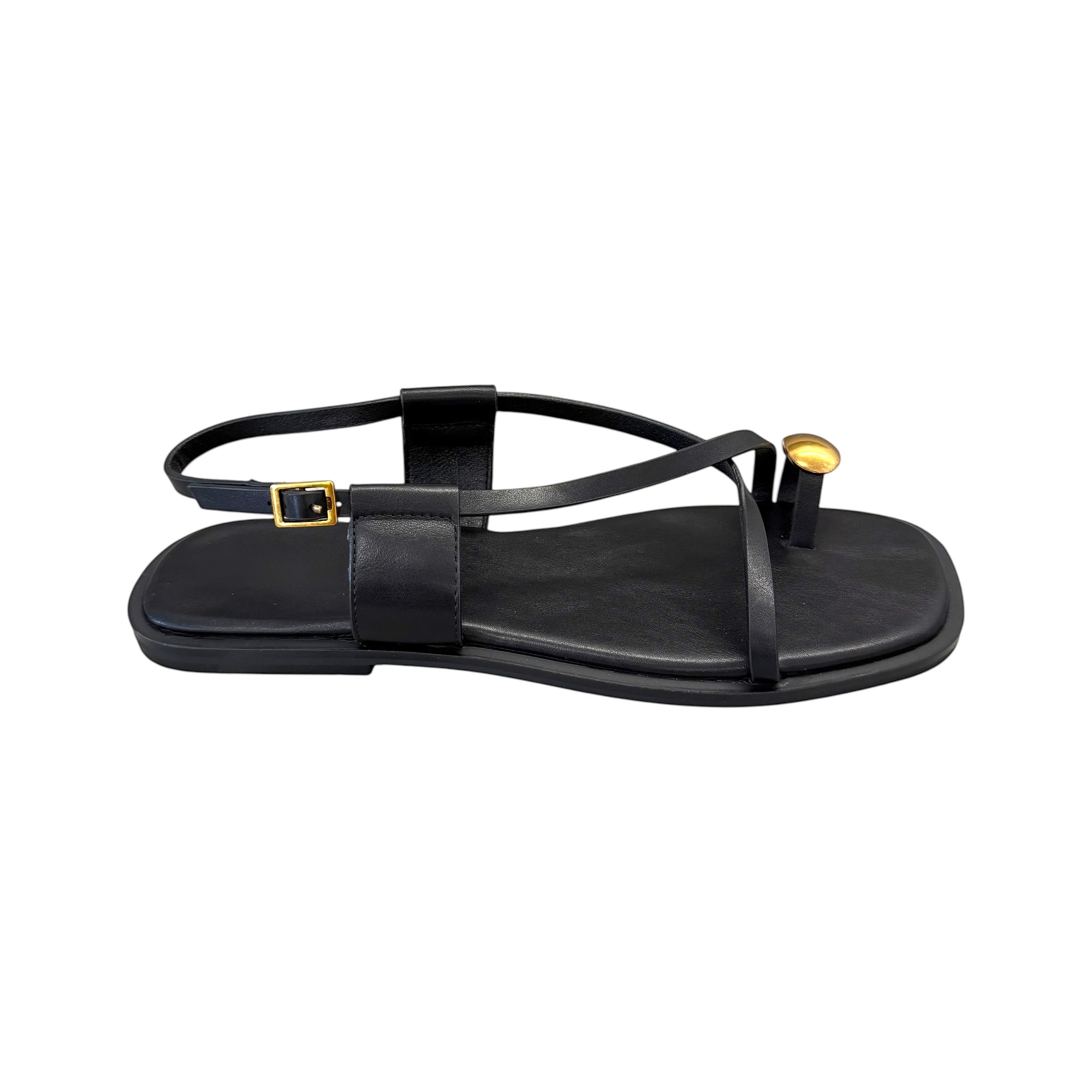 JESSICA black leather flat sandals with a gold ring detail on the toe strap and buckle closure.