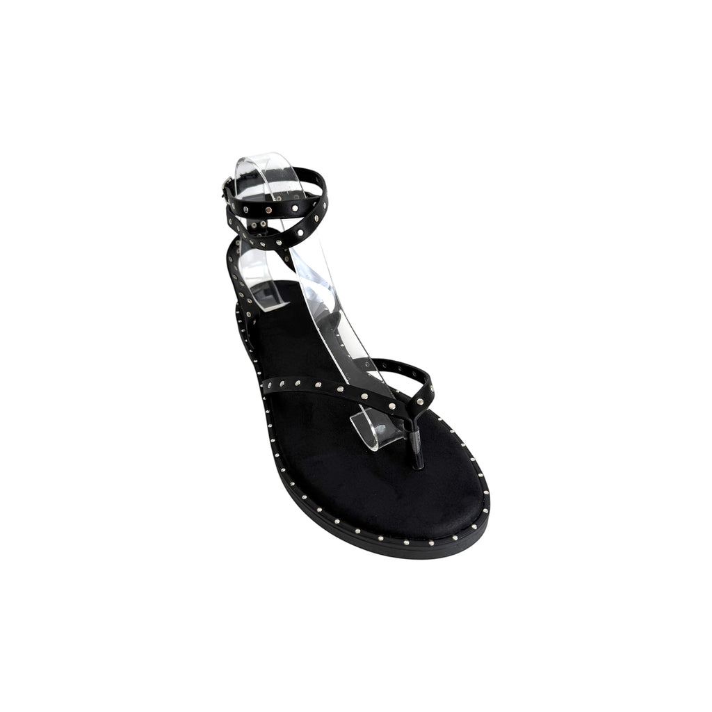 JESSICA black Roman sandals with ankle strap and silver stud details. Flat sole, thong toe.